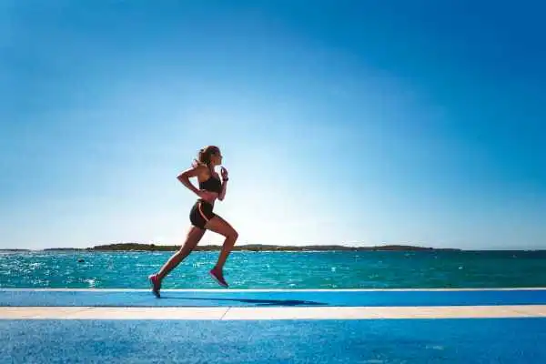 Woman running showing strong leg muscle Southsea
